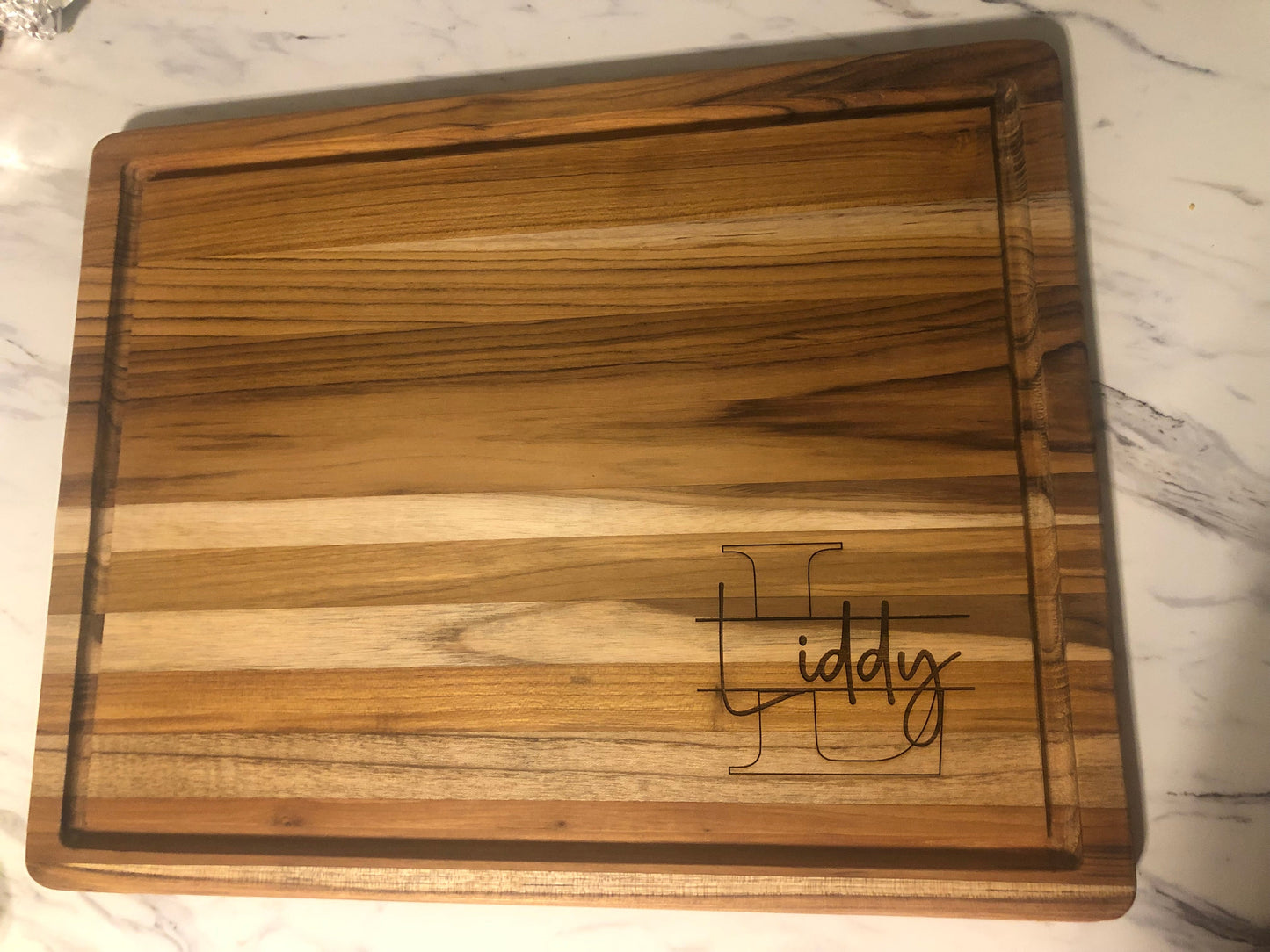 Blank teak charcuterie board showing natural wood grain