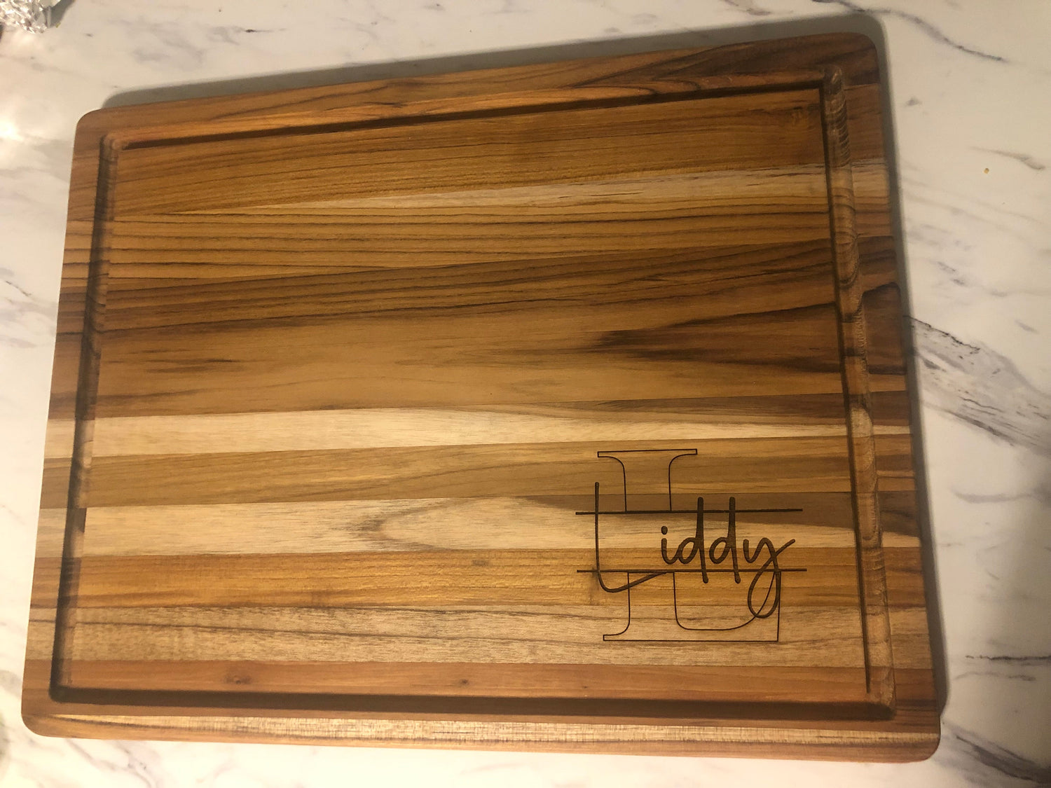 Blank teak charcuterie board showing natural wood grain